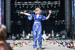 Runaway Country Music Fest, female singer holds microphone out to audience on stage runway